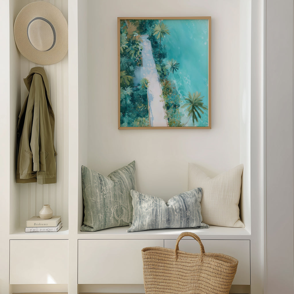 Nook with cushions, a hat, and a painting of a tropical scene.